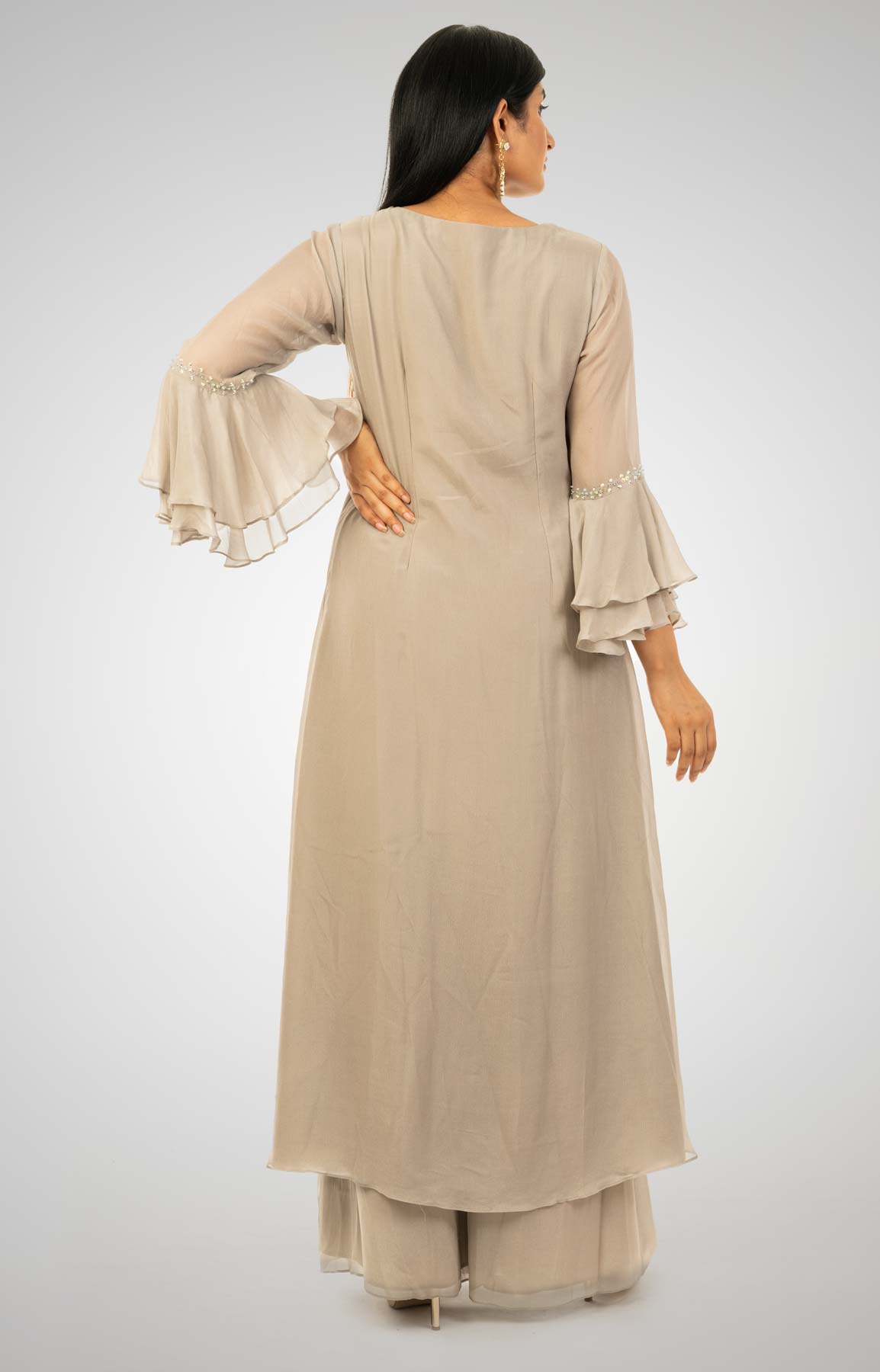 Glided Beige Crepe Palazzo Suit With A-Symmetrical A-line Kurta Adorned With Moti And Bead Work – Viraaya By Ushnakmals